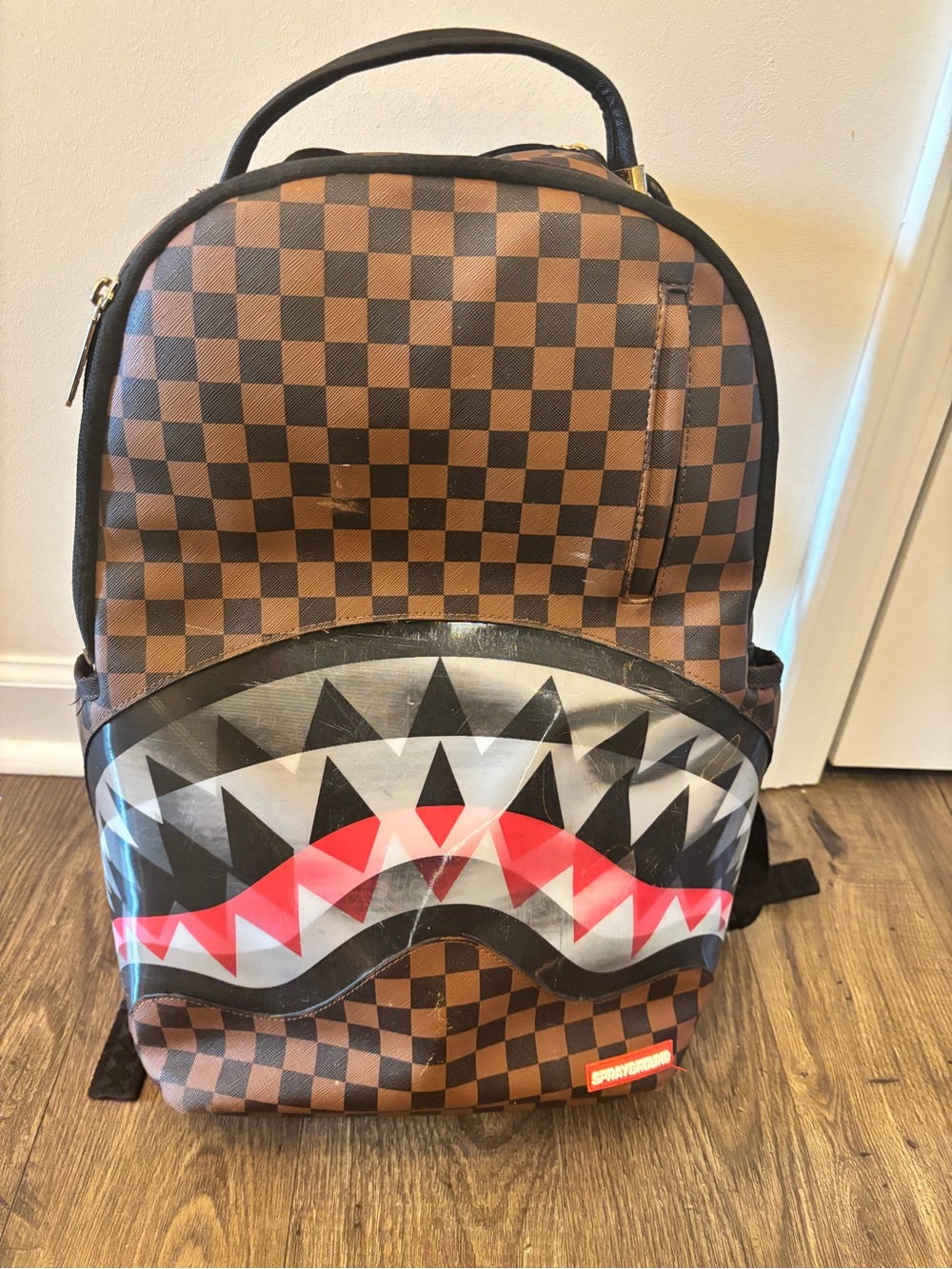 Sprayground Brown Checkered Backpack with Shark-Mouth Graphic